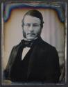 [Man in a suit with facial hair]