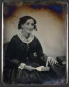 [Woman holding opened letter]