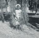 [Woman standing in willow tree branches]