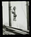 [Man on hoisting ball, Empire State Building]