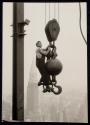 [Man on hoisting ball, Empire State Building]