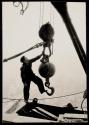[Worker with hoisting ball]