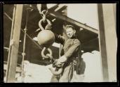 [Man holding hoisting ball]