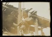 [Man on hoisting ball]