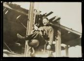 [Man on hoisting ball]