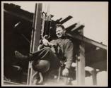 [Man on hoisting ball]