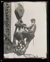 [Man on hoisting ball, Empire State Building]
