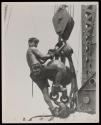 [Man on hoisting ball, Empire State Building]