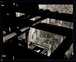 [Workers through beams, Empire State Building construction]