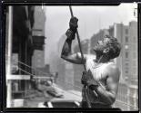 [Worker guiding a beam, Empire State Building construction]