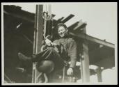 [Man on hoisting ball]