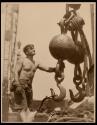 [Man with hoisting ball, Empire State Building]