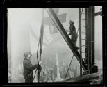 [Men raising flag, mooring mast, Empire State Building]