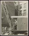 Steam shovel prepares foundation for big building.