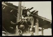 [Man on hoisting ball]