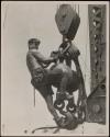 [Man on hoisting ball, Empire State Building]