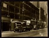 [Unloading trucks with derrick, Empire State building]