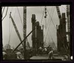 [Men placing steel beams, Empire State building construction]