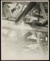 [Man using cutting torch on girders, Empire State Building]