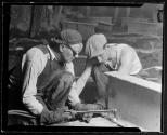 [Workers with cutting torch enlarging holes on girder, Empire State Building]