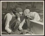 [Workers with cutting torch enlarging holes on girder, Empire State Building]