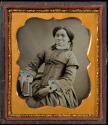 [Woman holding a book]