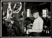 [Boy at spinning machine in cotton mill]