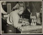 [Boy working in ice cream cone factory, Chicago]