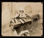 Skopje. Macedonian Serb mother nursing her baby in the cradle...