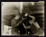 [Plumbers fitting pipes, Empire State building]