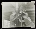 [Plumbers fitting pipes, Empire State building]