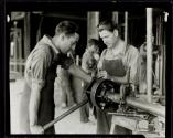 [Plumbers using pipe threader, Empire State building construction]