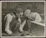[Workers with cutting torch enlarging holes on girder, Empire State Building]