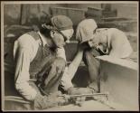 [Workers with cutting torch enlarging holes on girder, Empire State Building]