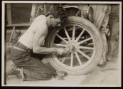 [Soldier fixing tire, Army training camp]