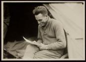 [Soldier reading letter, Army training camp]