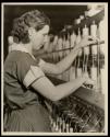 Spinner in a North Carolina cotton mill piecing-up. Room is very noisy, - the air humid and full of lint. High Point, North Carolina