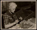 [Assembly line worker in glass factory]