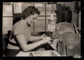 [Young girls do many semi-skilled jobs in the glass works. This one is grinding off rough edges on bottle stoppers. A N.J. Glass Works.]