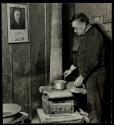Unemployed bachelor in coal miners camp on Scotts Run, W.Va. He is typical of the stranded men in an abandoned camp, - speaks English poorly but was proud of the portrait on the wall.
