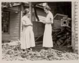 [Red Cross relief worker with flood victim]