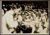 [Sailor performing magic trick for crowd, Naval training camp.]