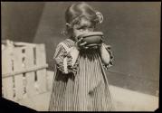 [French war orphan eating soup given by American relief.]