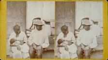 [African American couple (mother nursing baby)]