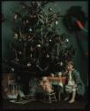 [Girl by Christmas tree]