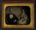 [Parents posing with deceased infant]