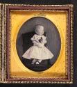 [Small deceased girl with flowers]