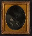 [Deceased child held by excised woman]