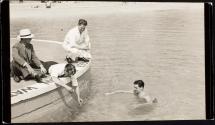[Men testing water in swimming pool]