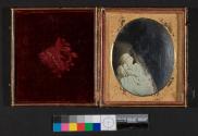 [Deceased child (held by woman, image erased)]